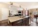 Open kitchen with island seating, granite countertops, and a view to the living room at 8484 Glenview St, Douglasville, GA 30134