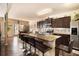 Spacious kitchen island with bar stool seating, stainless steel appliances, and granite countertops at 8484 Glenview St, Douglasville, GA 30134