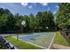 Community basketball court surrounded by lush trees and fencing, perfect for sports and recreation at 205 Finsbury Park Ct, Suwanee, GA 30024