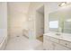 Bright bathroom featuring a soaking tub, glass enclosed shower, and double sink vanity at 205 Finsbury Park Ct, Suwanee, GA 30024