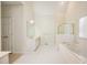 Bright bathroom featuring a soaking tub, glass enclosed shower, and double sink vanity at 205 Finsbury Park Ct, Suwanee, GA 30024