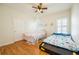 Comfortable ' bedroom with hardwood floors, ceiling fan, and two beds at 205 Finsbury Park Ct, Suwanee, GA 30024
