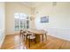 Elegant dining room with high ceilings, a large window, and a modern dining set at 205 Finsbury Park Ct, Suwanee, GA 30024