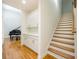 Hallway featuring hardwood floors, a staircase, and built in cabinets and shelving at 205 Finsbury Park Ct, Suwanee, GA 30024