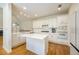 Bright kitchen with white cabinets, stainless steel appliances, and center island with counter seating at 205 Finsbury Park Ct, Suwanee, GA 30024