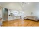 Open living room featuring hardwood floors, high ceilings, and seamless access to the modern kitchen at 205 Finsbury Park Ct, Suwanee, GA 30024