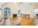 Spacious living room with hardwood floors, fireplace, and many windows at 205 Finsbury Park Ct, Suwanee, GA 30024
