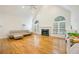 Spacious living room with hardwood floors, fireplace, and many windows at 205 Finsbury Park Ct, Suwanee, GA 30024