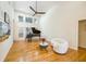 Spacious living room with a piano, modern furniture, and hardwood flooring at 205 Finsbury Park Ct, Suwanee, GA 30024