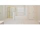 Bright main bathroom with a soaking tub, separate shower, and tile flooring at 205 Finsbury Park Ct, Suwanee, GA 30024