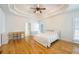 Spacious main bedroom with a tray ceiling, hardwood floors, and natural light at 205 Finsbury Park Ct, Suwanee, GA 30024