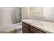 Bathroom featuring a shower-tub combo and a sink with granite countertop and dark cabinets at 2277 Church St, Hampton, GA 30228