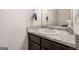 Bathroom featuring a sink with light countertop, dark cabinets, and a towel rack, offering a functional space at 2277 Church St, Hampton, GA 30228