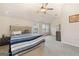 Large bedroom with a ceiling fan, carpet flooring, and natural light from multiple windows at 2277 Church St, Hampton, GA 30228