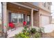 Inviting front porch with red chairs, brick facade, and a view of the home's exterior at 2277 Church St, Hampton, GA 30228