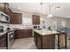 Spacious kitchen with stainless steel appliances, granite countertops, dark wood cabinets, and kitchen island at 2277 Church St, Hampton, GA 30228