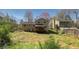Expansive backyard featuring a covered deck, providing a private outdoor space with mature trees in a suburban setting at 494 Rue Montaigne, Stone Mountain, GA 30083