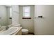 Small half bathroom with toilet and single sink at 494 Rue Montaigne, Stone Mountain, GA 30083