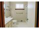 Bathroom featuring a toilet, sink, and a tiled shower at 494 Rue Montaigne, Stone Mountain, GA 30083
