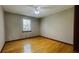 Bedroom featuring hardwood floors, a window, and neutral walls at 494 Rue Montaigne, Stone Mountain, GA 30083