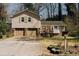 Charming home featuring a two-car garage, stone accents, and well-maintained landscaping at 494 Rue Montaigne, Stone Mountain, GA 30083