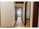 Long hallway featuring hardwood floors and leading to bedrooms and other living spaces at 494 Rue Montaigne, Stone Mountain, GA 30083