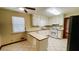 Bright kitchen with white cabinets, tiled floors, and new stainless steel gas range at 494 Rue Montaigne, Stone Mountain, GA 30083
