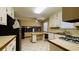 Eat-in kitchen featuring white cabinets, tiled floors, and breakfast bar at 494 Rue Montaigne, Stone Mountain, GA 30083