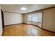 Spacious living room with wood flooring and large window at 494 Rue Montaigne, Stone Mountain, GA 30083