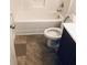 Bathroom showcasing a standard white toilet, tub with shower, and dark vanity at 1188 To Lani Path, Stone Mountain, GA 30083