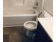 Bathroom showcasing a standard white toilet, tub with shower, and dark vanity at 1188 To Lani Path, Stone Mountain, GA 30083