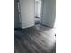 Bright room with wood floors and doorway access to a carpeted bedroom at 1188 To Lani Path, Stone Mountain, GA 30083