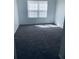Bedroom featuring a window with blinds and neutral-colored carpet at 1188 To Lani Path, Stone Mountain, GA 30083