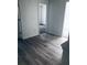 Bright room with wood floors and doorway access to a carpeted bedroom at 1188 To Lani Path, Stone Mountain, GA 30083