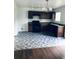 Modern kitchen featuring dark wood cabinetry, a black stove, herringbone pattern flooring and stainless steel sink at 1188 To Lani Path, Stone Mountain, GA 30083