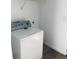 Laundry room area with a white washing machine, white walls, and basic shelving at 1188 To Lani Path, Stone Mountain, GA 30083