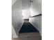 View of a stairway with dark carpet on the stairs, white walls, and black banisters at 1188 To Lani Path, Stone Mountain, GA 30083