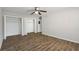 Bedroom features hardwood floor, ceiling fan and closet with doors open at 2825 Northeast Ne Expy # F003, Atlanta, GA 30345