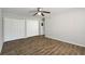Bedroom features hardwood floor, ceiling fan and double closets at 2825 Northeast Ne Expy # F003, Atlanta, GA 30345