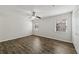 A bright bedroom is shown with a ceiling fan, two windows, and dark flooring at 2825 Northeast Ne Expy # F003, Atlanta, GA 30345