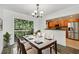 Bright dining room features a modern chandelier, slider to deck, and a convenient pass-through to the kitchen at 2825 Northeast Ne Expy # F003, Atlanta, GA 30345