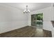 Dining room with modern light fixture, wainscoting, hardwood floor, and a sliding door at 2825 Northeast Ne Expy # F003, Atlanta, GA 30345