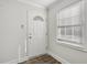 Entryway shows front door with decorative glass and a window with white blinds at 2825 Northeast Ne Expy # F003, Atlanta, GA 30345