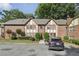 Brick condo building with Tudor-style accents, mature landscaping, and parking at 2825 Northeast Ne Expy # F003, Atlanta, GA 30345