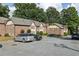 The property features red brick and Tudor accents with manicured landscaping and parking at 2825 Northeast Ne Expy # F003, Atlanta, GA 30345