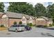 Brick apartment building with a parking lot, green trees, and a well-maintained lawn at 2825 Northeast Ne Expy # F003, Atlanta, GA 30345