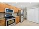 Kitchen with stainless appliances, stone backsplash, and bright cabinets at 2825 Northeast Ne Expy # F003, Atlanta, GA 30345