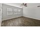 Bright living room with hardwood floors, three windows and white trim throughout at 2825 Northeast Ne Expy # F003, Atlanta, GA 30345