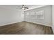 Bright living room with wood floor features multiple windows and neutral paint at 2825 Northeast Ne Expy # F003, Atlanta, GA 30345