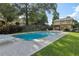 Community pool with chairs, lush landscaping, and a stone wall at 2825 Northeast Ne Expy # F003, Atlanta, GA 30345